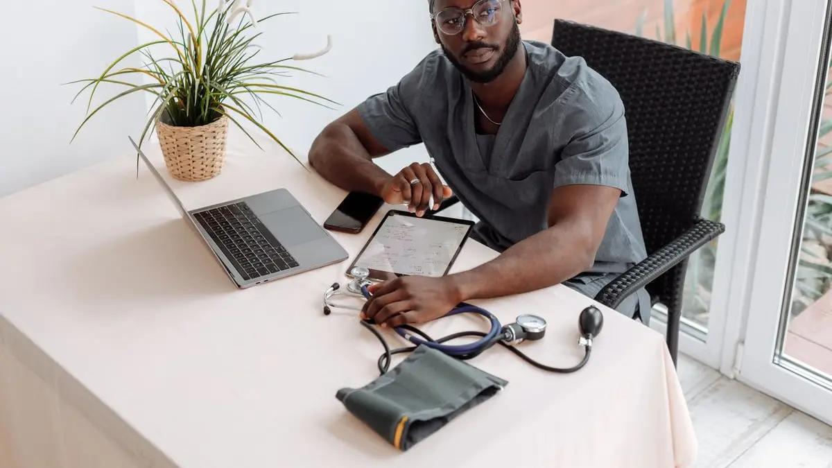 A health worker with a blood pressure monitor
