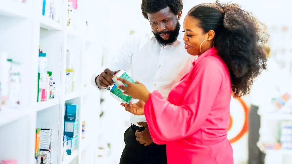 A pharmacist advising a customer about medicine
